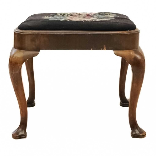 45 - A George II walnut stool. With embroidered drop-in seat, and raised on cabriole legs with trefoil sh... 