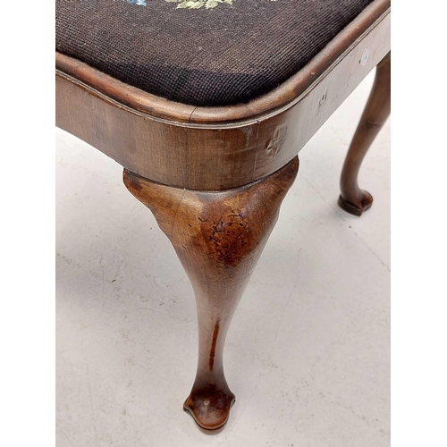 45 - A George II walnut stool. With embroidered drop-in seat, and raised on cabriole legs with trefoil sh... 