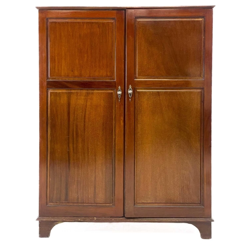 46 - A Gentleman's mahogany Compactum wardrobe. Fitted with two doors, each set twin fielded panels, and ... 