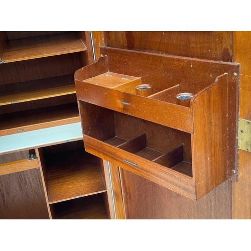 46 - A Gentleman's mahogany Compactum wardrobe. Fitted with two doors, each set twin fielded panels, and ... 