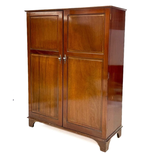 46 - A Gentleman's mahogany Compactum wardrobe. Fitted with two doors, each set twin fielded panels, and ... 