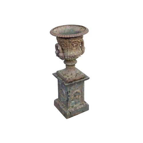 526 - A classical style cast iron garden urn on stand. Early 20th century, of campana form, with gadrooned... 