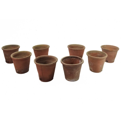 527 - A collection of eight terracotta flower pots. Height 23cm.