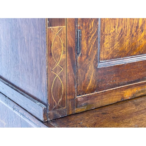 56 - A 19th century oak estate cabinet. The upper with twin cupboard doors enclosing three shelves above ... 