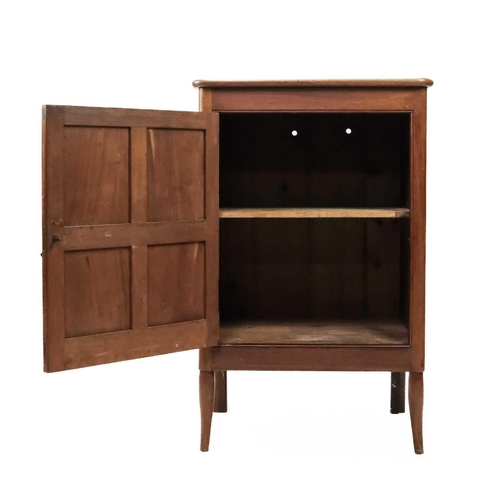 57 - An Arts and Crafts Cotswold school walnut side cupboard. With a single four panelled door, raised on... 