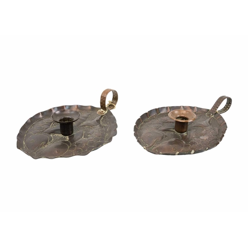 8 - A pair of Arts & Crafts copper chamber sticks or candle holders Circa 1920, of oval section, each wi... 