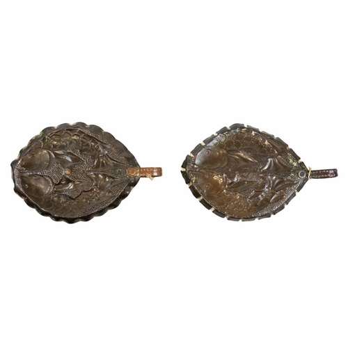 8 - A pair of Arts & Crafts copper chamber sticks or candle holders Circa 1920, of oval section, each wi... 