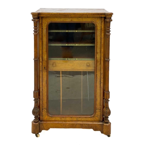 82 - A Victorian walnut and inlaid music cabinet. With a single glazed door enclosing a drawer, shelves a... 