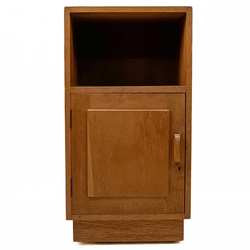 83 - Gordon Russell (1892-1980) A pair of oak bedside cabinets with an open shelf above a single cupboard... 