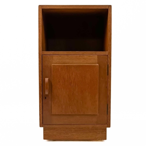 83 - Gordon Russell (1892-1980) A pair of oak bedside cabinets with an open shelf above a single cupboard... 