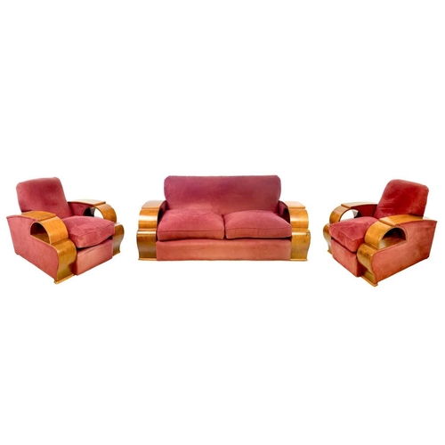 85 - An Art Deco walnut veneer upholstered three piece suite. Comprising: a three seater and two armchair... 