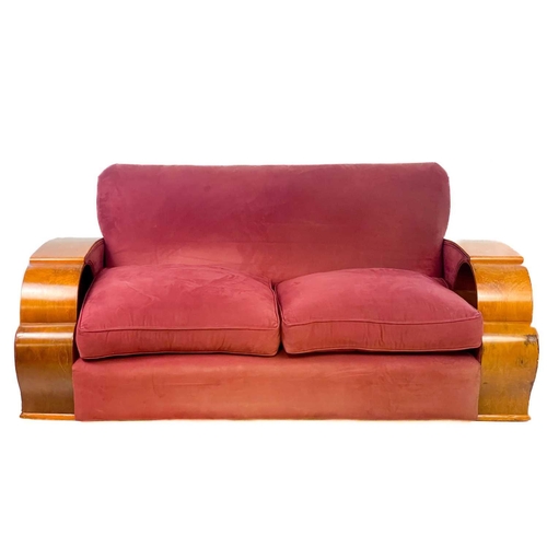 85 - An Art Deco walnut veneer upholstered three piece suite. Comprising: a three seater and two armchair... 