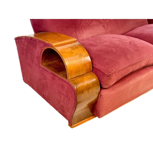 85 - An Art Deco walnut veneer upholstered three piece suite. Comprising: a three seater and two armchair... 