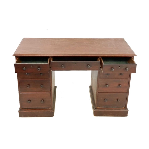 88 - A Victorian mahogany pedestal desk. With an arrangement of nine drawers on plinth bases and castor w... 