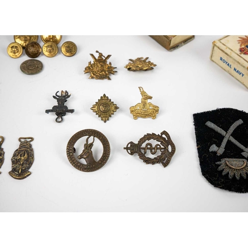 213 - Military badges, buttons, Trench Art etc Comprising: 1: Six military badges from South Africa 2: 191... 