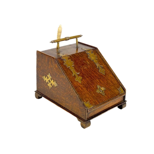 120 - An early 20th century brass bound oak novelty tea caddy. Modelled as a slope fronted coal box with b... 