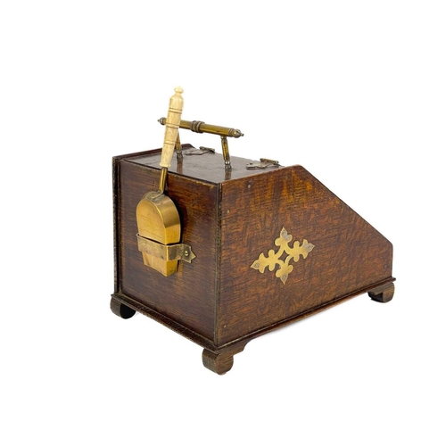120 - An early 20th century brass bound oak novelty tea caddy. Modelled as a slope fronted coal box with b... 