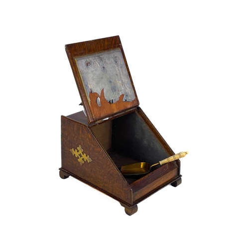 120 - An early 20th century brass bound oak novelty tea caddy. Modelled as a slope fronted coal box with b... 