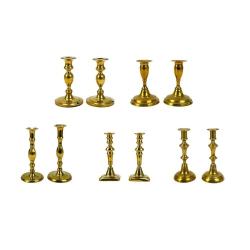 121 - A pair of 19th century brass candlesticks. With faceted knop, height 24cm together with four other p... 