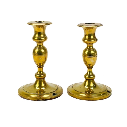 121 - A pair of 19th century brass candlesticks. With faceted knop, height 24cm together with four other p... 