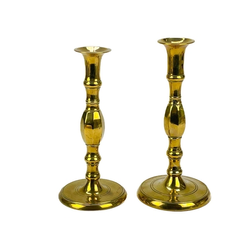 121 - A pair of 19th century brass candlesticks. With faceted knop, height 24cm together with four other p... 