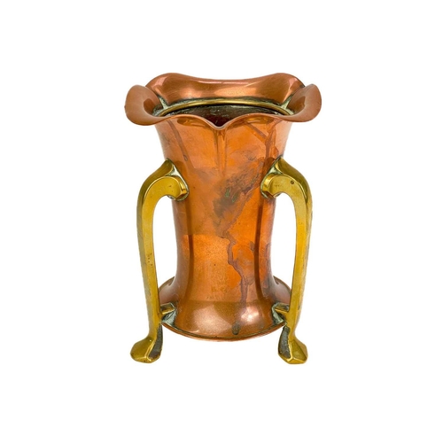 125 - A copper chamberstick by Henry Loveridge. Diameter 18cm, together with an Art Nouveau copper and bra... 