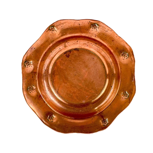 125 - A copper chamberstick by Henry Loveridge. Diameter 18cm, together with an Art Nouveau copper and bra... 