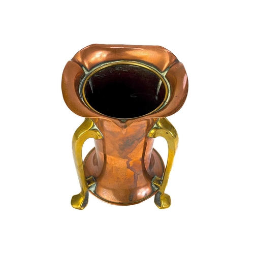 125 - A copper chamberstick by Henry Loveridge. Diameter 18cm, together with an Art Nouveau copper and bra... 