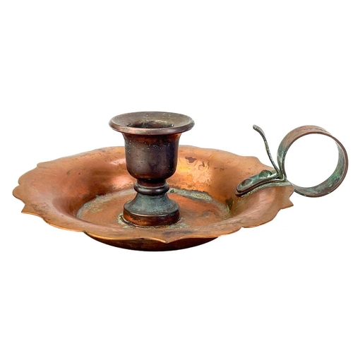 125 - A copper chamberstick by Henry Loveridge. Diameter 18cm, together with an Art Nouveau copper and bra... 