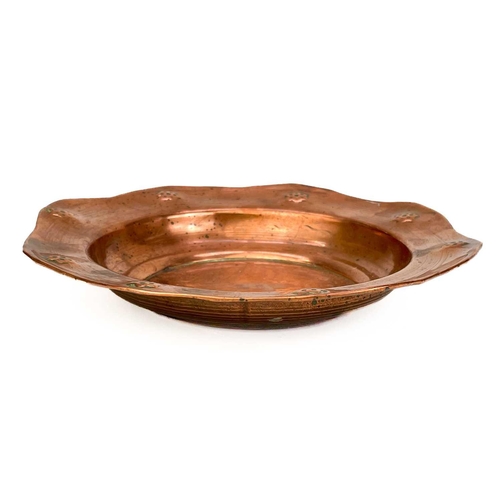 125 - A copper chamberstick by Henry Loveridge. Diameter 18cm, together with an Art Nouveau copper and bra... 