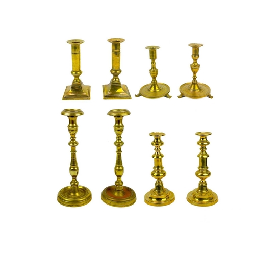 126 - A pair of 18th century brass candlesticks. Height 32cm together with four other 19th century brass c... 
