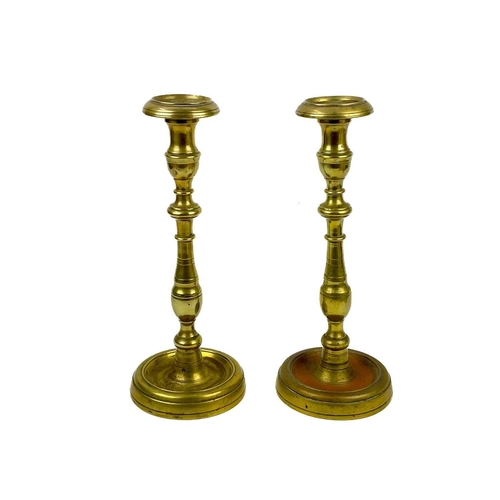 126 - A pair of 18th century brass candlesticks. Height 32cm together with four other 19th century brass c... 