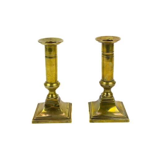 126 - A pair of 18th century brass candlesticks. Height 32cm together with four other 19th century brass c... 
