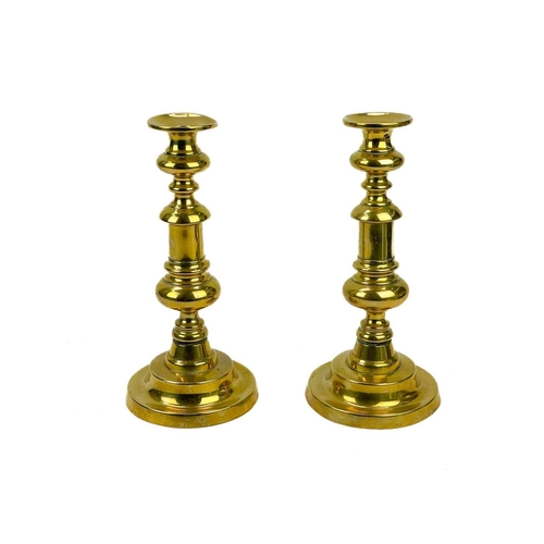 126 - A pair of 18th century brass candlesticks. Height 32cm together with four other 19th century brass c... 