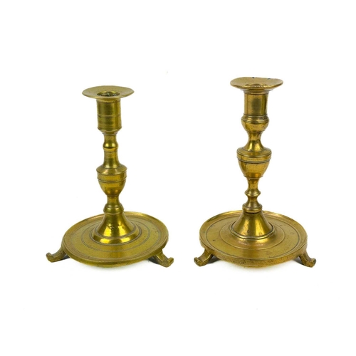 126 - A pair of 18th century brass candlesticks. Height 32cm together with four other 19th century brass c... 