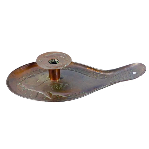 127 - An Arts and Crafts Newlyn copper candleholder. Repousse decorated with a plaice, the wax guard furth... 