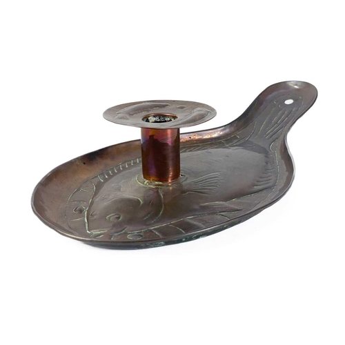 127 - An Arts and Crafts Newlyn copper candleholder. Repousse decorated with a plaice, the wax guard furth... 