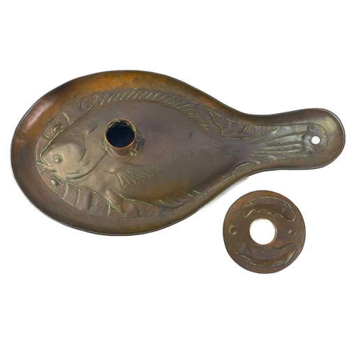 127 - An Arts and Crafts Newlyn copper candleholder. Repousse decorated with a plaice, the wax guard furth... 
