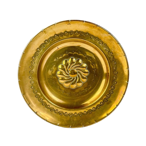 128 - A large brass circular alms dish. With central gadrooned decoration, diameter 41.5cm together with t... 