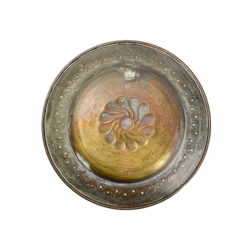 128 - A large brass circular alms dish. With central gadrooned decoration, diameter 41.5cm together with t... 