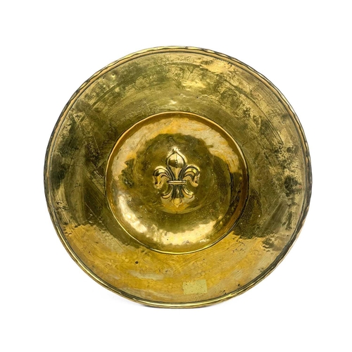 128 - A large brass circular alms dish. With central gadrooned decoration, diameter 41.5cm together with t... 