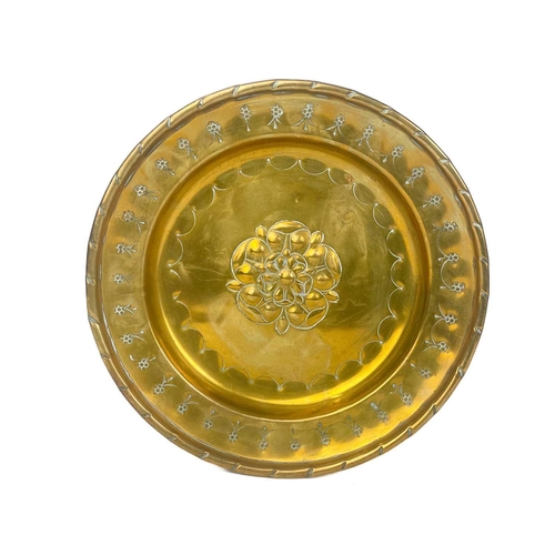 128 - A large brass circular alms dish. With central gadrooned decoration, diameter 41.5cm together with t... 