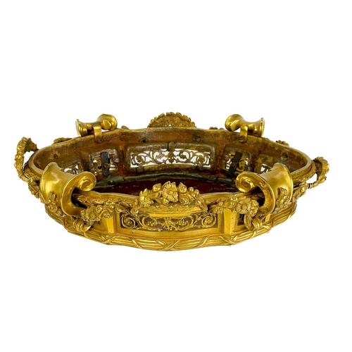 129 - A pair of neo-classical French ormolu, shaped base mounts. With foliate pierced panels below a reed ... 