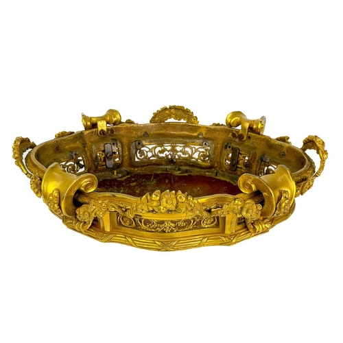 129 - A pair of neo-classical French ormolu, shaped base mounts. With foliate pierced panels below a reed ... 