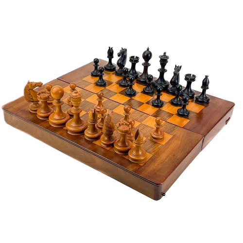 130 - An ebony and boxwood Staunton pattern chess set. Height of king 8.5cm, together with a folding chess... 