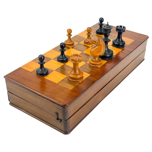130 - An ebony and boxwood Staunton pattern chess set. Height of king 8.5cm, together with a folding chess... 