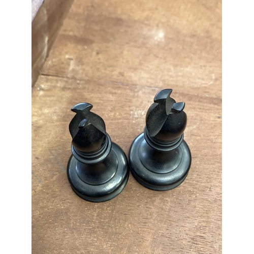 130 - An ebony and boxwood Staunton pattern chess set. Height of king 8.5cm, together with a folding chess... 