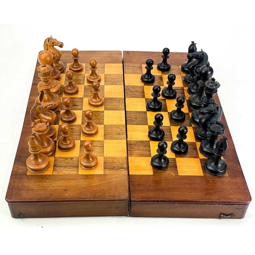 130 - An ebony and boxwood Staunton pattern chess set. Height of king 8.5cm, together with a folding chess... 