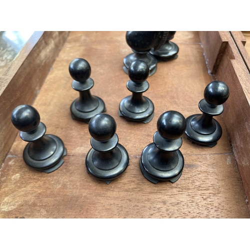 130 - An ebony and boxwood Staunton pattern chess set. Height of king 8.5cm, together with a folding chess... 