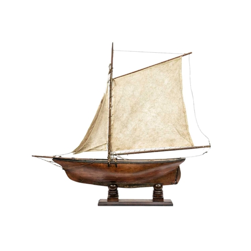 133 - A 19th century pond yacht. With authentic rigging and mahogany stand, height 85cm.